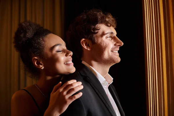 Cheerful african american woman hugging shoulders of handsome man during date, romance and love — Stock Photo