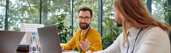 Two jolly businessmen in casual vivid attires discussing their important startup at table, banner — Stock Photo