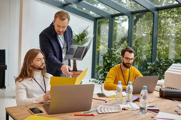 Happy good looking businessmen in casual attire working attentively on their startup together — Stock Photo