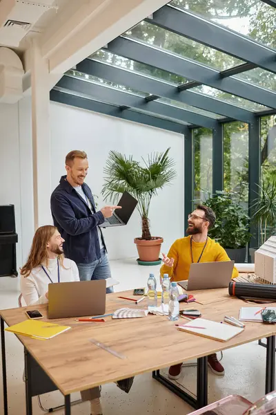 Joyful attractive businessmen in casual attire working attentively on their startup together — Stock Photo
