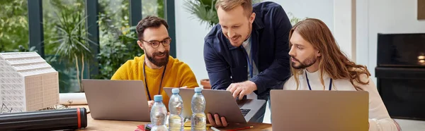 Merry attractive businessmen in casual attire working attentively on their startup together, banner — Stock Photo