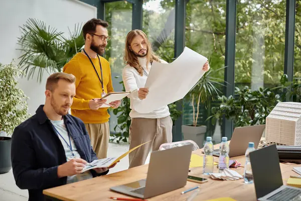 Focused good looking architects discussing their startup and checking drafts, business concept — Stock Photo