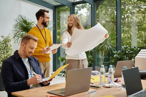 Joyous appealing businessmen in casual outfit working attentively on their startup together — Stock Photo