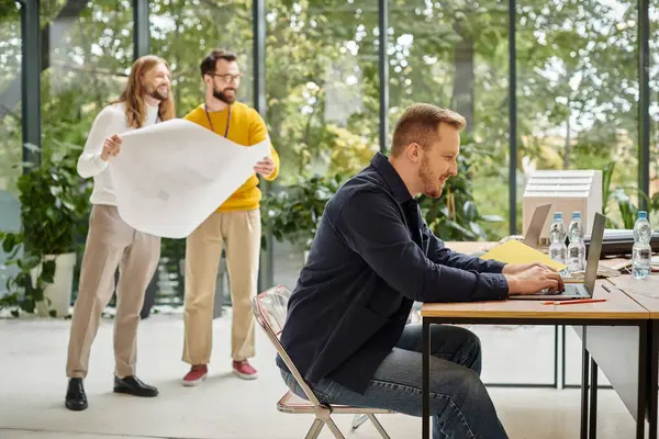 Empresários de boa aparência alegre em roupa casual trabalhando duro em sua própria startup juntos — Fotografia de Stock