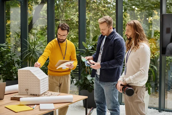 Focused good looking coworkers in casual clothes working together on their startup, business — Stock Photo