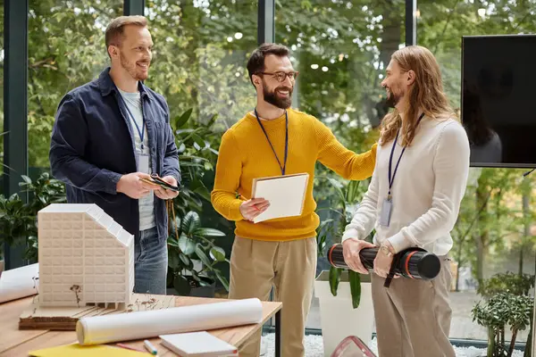 Joyful attractive architects in casual outfits working together on their startup, coworking concept — Stock Photo
