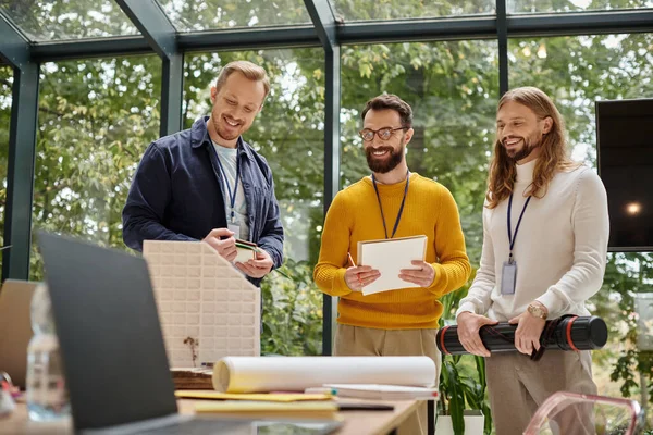 Joyous attractive architects in casual outfits working together on their startup, coworking concept — Stock Photo