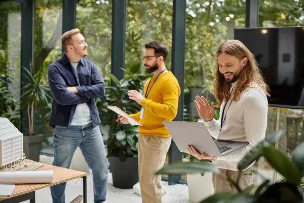 Focus on jolly man in casual attire having videocall and his blurred colleagues discussing startup — Stock Photo
