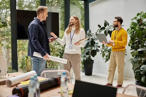 Good looking merry architects in comfy attires working together on their startup, coworking concept — Stock Photo