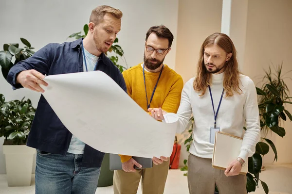 Concentrated attractive coworkers in casual attires working together on their startup, business — Stock Photo