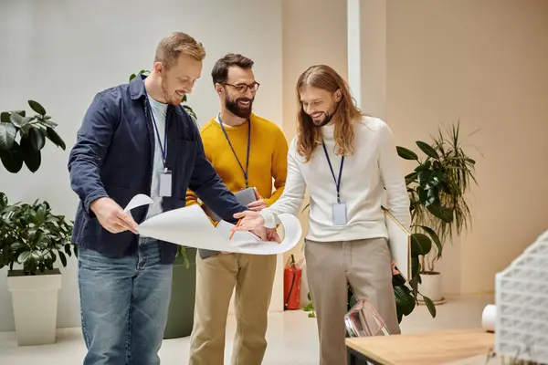 Happy attractive architects in casual attires working together on their startup, coworking concept — Stock Photo