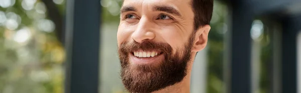 Handsome cheerful architect in comfy yellow turtleneck with beard posing and looking away, banner — Stock Photo