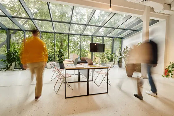 Long exposure photo of colleagues posing in blurred motion in their office while working on startup — Stock Photo