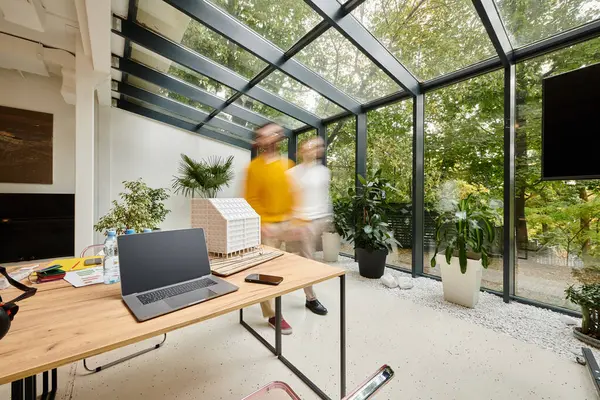 Long exposure photo of dedicated young coworkers moving around their office, startup, motion blur — Stock Photo