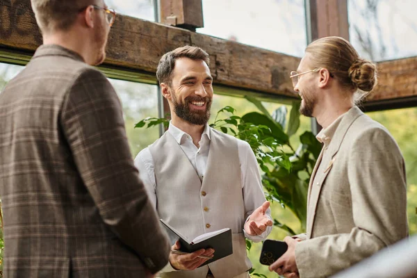 Joyous good looking business leaders with glasses in sophisticated attires working on their startup — Stock Photo