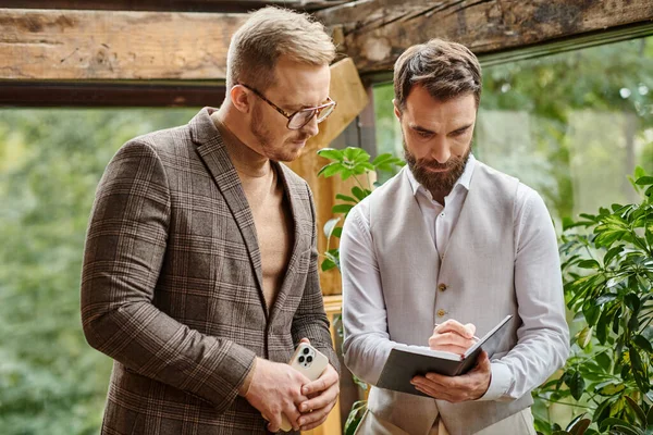 Focused handsome business leaders in sophisticated clothes posing together while working hard — Stock Photo