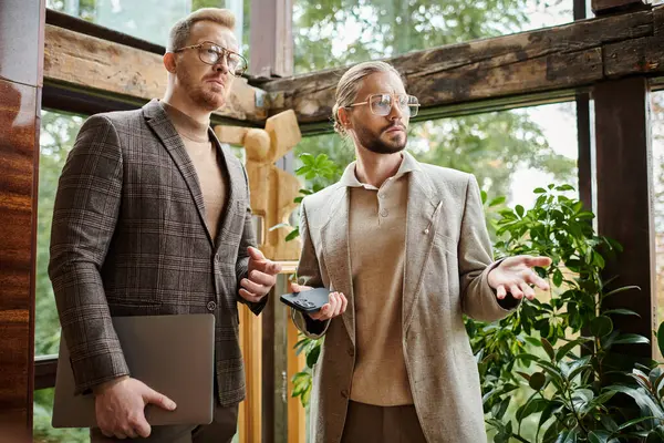 Focused handsome business leaders in fashionable clothes posing together while working hard — Stock Photo