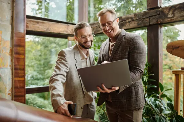 Happy handsome business leaders with glasses in fashionable attires discussing their startup — Stock Photo