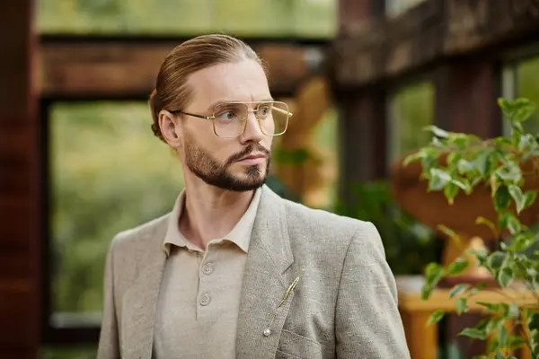 Appealing elegant leader with collected hair in glasses in chic fashionable suit posing attractively — Stock Photo