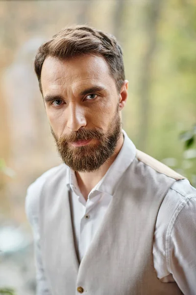Handsome concentrated leader with beard in sophisticated attire looking at camera, business concept — Stock Photo