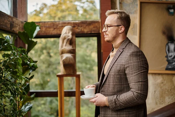 Focused sophisticated business leader with glasses in elegant suit drinking his hot coffee — Stock Photo