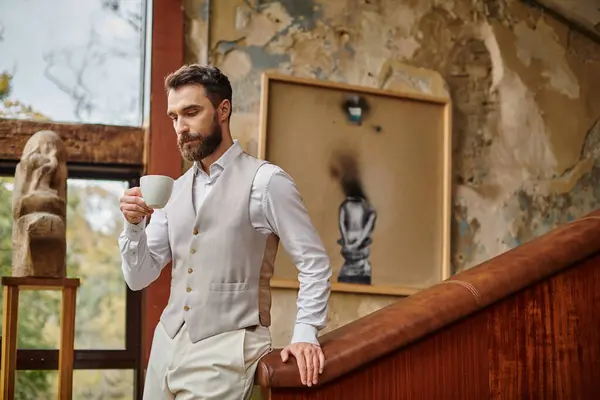 Concentrated attractive business leader with beard with elegant dapper style drinking his coffee — Stock Photo