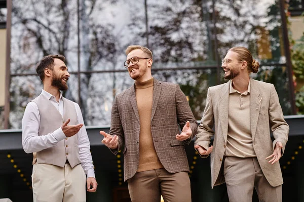 Cheerful handsome business leaders with glasses in fashionable attires discussing their startup — Stock Photo
