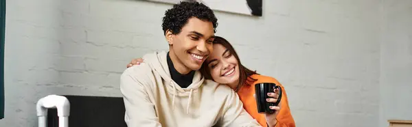 Happy diverse couple, young joyful woman with cup of coffee leaning on shoulder on black boyfriend — Stock Photo