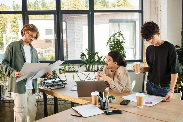 Young man discussing his startup ideas on new project with colleague analyzing chars in office — Stock Photo