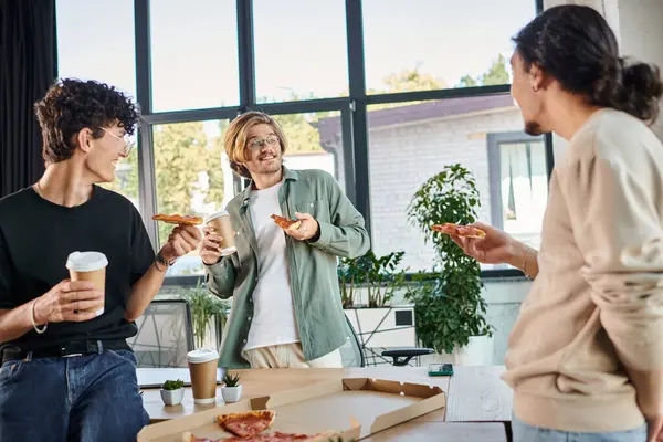 Happy men enjoying a pizza in a friendly and relaxed atmosphere, startup team having lunch break — Stock Photo