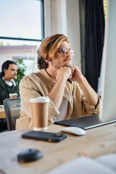 Focused man working on creative project and looking at monitor in coworking, retouching team — Stock Photo