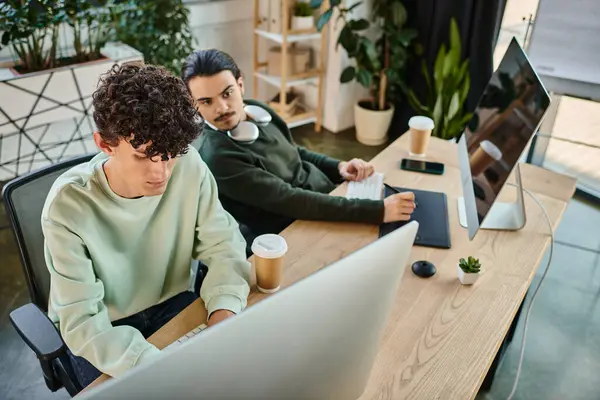 Coworkers collaborating on retouching tasks in a startup post-production office, men in 20s — Stock Photo