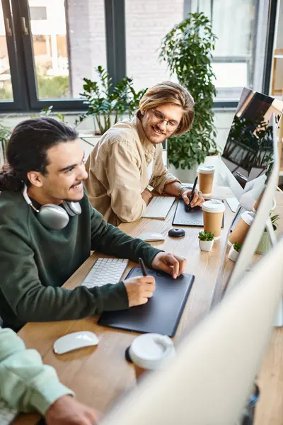 Young post production team smiling and editing photos in modern office space, cheerful men in 20s — Stock Photo