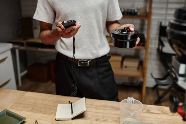 African american photographer using darkroom timer, a tool in precise art of film development — Stock Photo