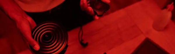 Fotografo ritagliato in camera oscura a luci rosse, uomo nero con timer, banner di sviluppo del film — Foto stock