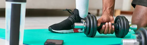 Cropped view of fit african american man in sportswear working out with dumbbell at home, banner — Stock Photo