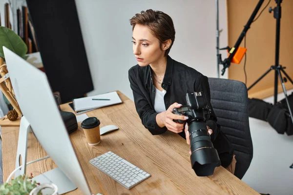 Pretty professional female photographer in casual wear retouching photos on computer at her studio — Stock Photo