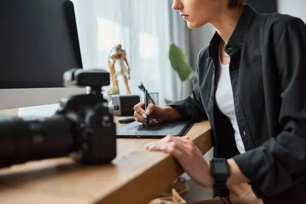 Cropped view of young female designer sitting at table and using her drawing tablet for work — Stock Photo