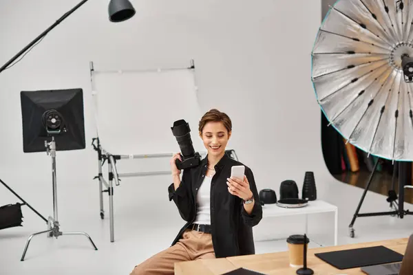 Merry pretty female photographer in casual attire making stories for her social media in her studio — Stock Photo