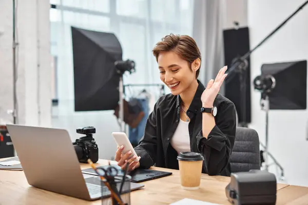 Jolly attractive female photographer in casual attire making stories for social media in her studio — Stock Photo
