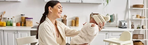 Good looking woman in cozy homewear posing with her cute newborn baby boy, modern parenting, banner — Stock Photo