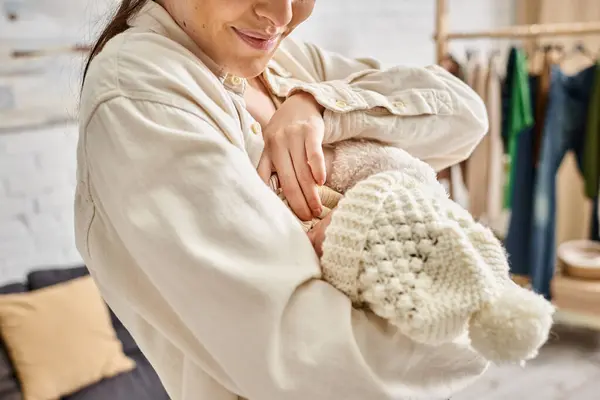 Appealing caring happy mother in cozy homewear breastfeeding her newborn child, modern parenting — Stock Photo