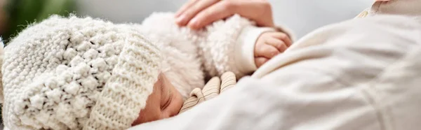 Cropped view of mother holding lovingly her newborn child and breastfeeding him, modern parenting — Stock Photo