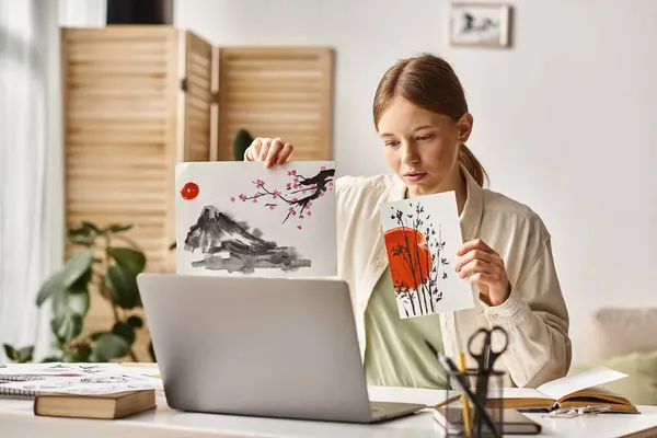 Teenage girl showing her artwork while studying and looking at her laptop, online art class — Stock Photo