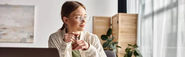 Teenage girl in glasses holding pen and thinking during online class at home, horizontal banner — Stock Photo