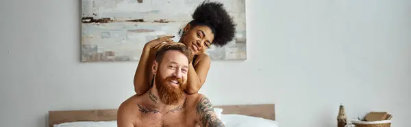 Happy diverse couple, african american woman embracing her tattooed man in bedroom, banner — Stock Photo