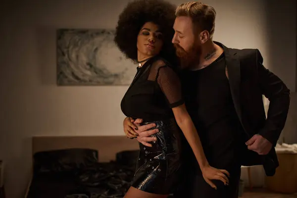 Tattooed and bearded man seducing curly african american woman in dress during date, sexy couple — Stock Photo