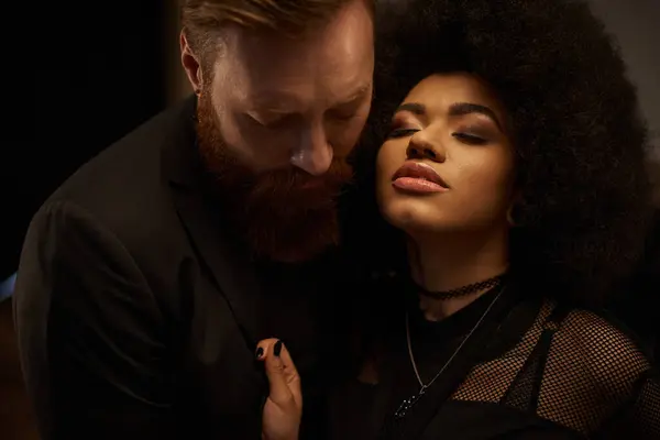 Curly african american woman in dress pulling blazer of bearded boyfriend during date, sexy couple — Stock Photo