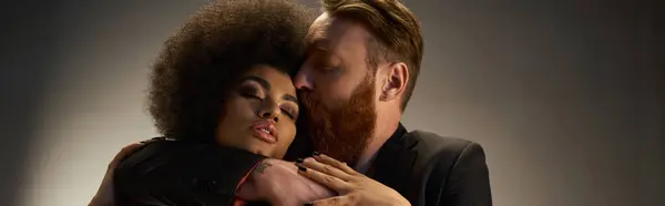 Bearded man kissing african american woman with curly hair, intimate moment of sexy couple banner — Stock Photo