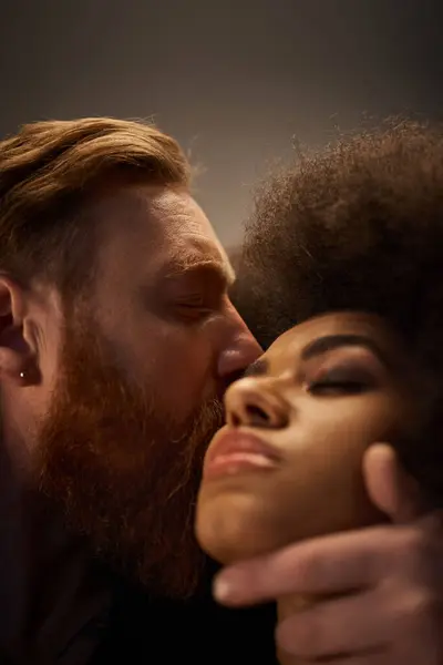 Bearded man kissing sexy african american woman with curly hair, intimate moment of hot couple — Stock Photo